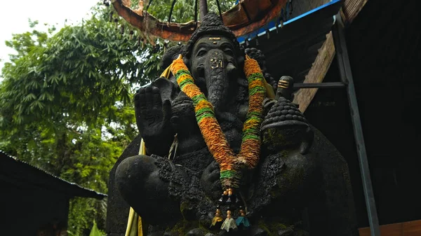 depositphotos_479473118-stock-photo-old-stone-statue-ganesha-covered